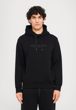 Black hooded sweatshirt made of soft fabric featuring a front logo in dark print. Includes adjustable drawstrings and ribbed cuffs.