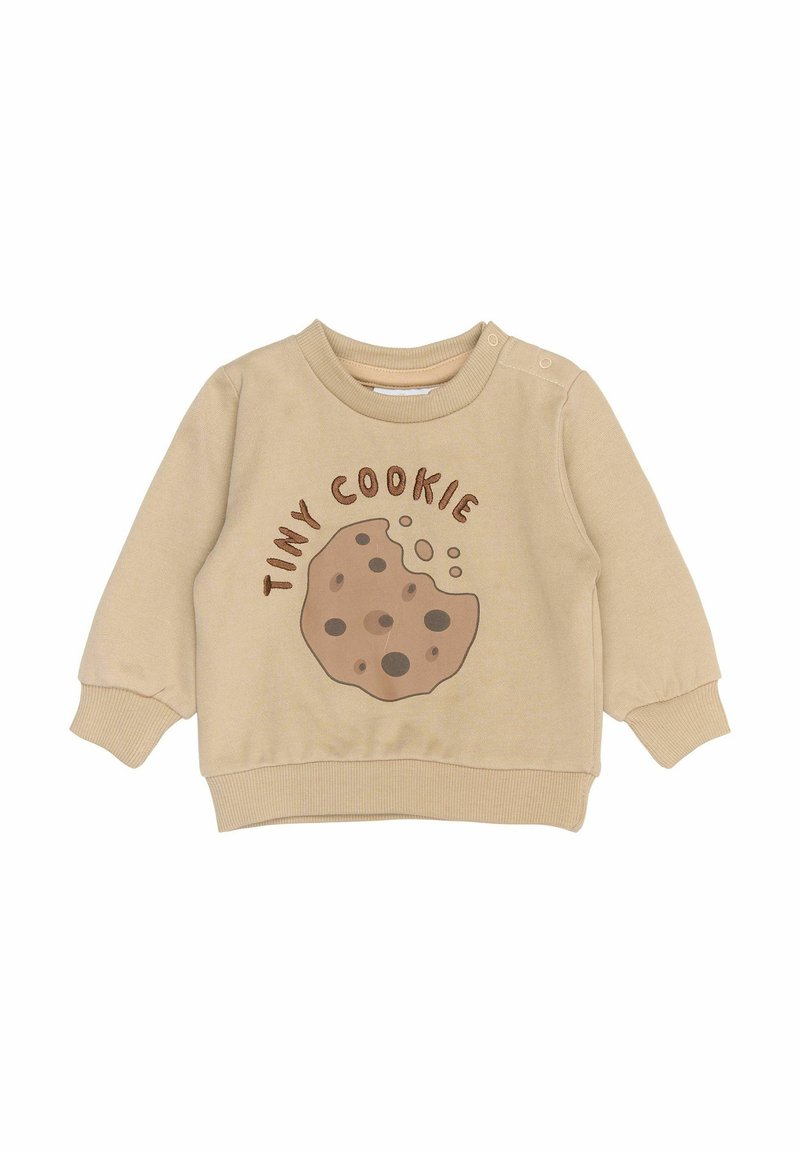 Béžová mikina se grafikou sušenky, která obsahuje akcenty tmavé čokolády a text "TINY COOKIE". Obsahuje kulatý výstřih a žebrované manžety.