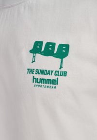 White t-shirt featuring a green graphic of three chairs and the text "THE SUNDAY CLUB" and "hummel SPORTSWEAR" below the design.