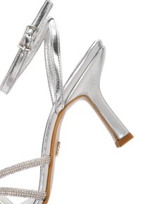 Sandali alti argentati con finitura lucida, design a strisce, abbelliti con strass lungo le cinghie e un elegante tacco stiletto.
