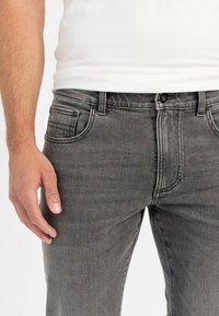 Gray denim jeans with a classic fit, featuring a button closure, front pockets, and a subtle faded texture.