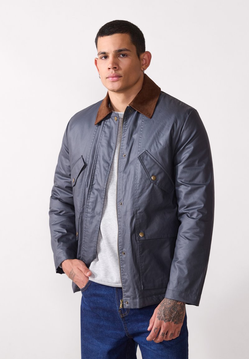 Gray, water-resistant jacket with a brown corduroy collar, zip fastening, and buttoned chest pockets; smooth texture and casual design.