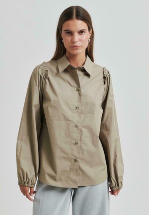 Olive green button-up shirt with gathered shoulder details, long sleeves, and elastic cuffs, made of a smooth, lightweight fabric.