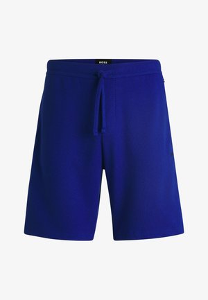 Blå strikkede shorts med elastisk talje og snoretræk, der har en tekstureret stof og diskret logo-detalje på siden.