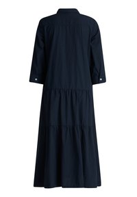 Navy sininen, pitkähihainen mekko, joka on valmistettu puuvillasta. Mekossa on kerroksellinen hameosa, napitettu hihansuu ja kauluskotelo. Sileä, tekstuuri kangas.