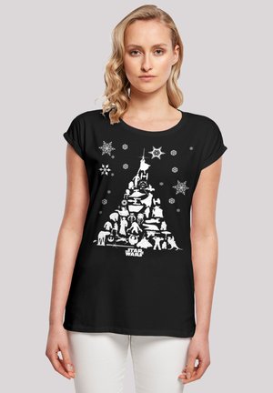 T-shirt noir avec un design graphique blanc représentant un sapin de Noël composé de personnages et de symboles de Star Wars, agrémenté de flocons de neige.