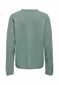 Sweat-shirt vert clair en tissu doux, doté d'un col rond, d'épaules tombantes, et d'un ourlet ainsi que de poignets côtelés pour une coupe décontractée.