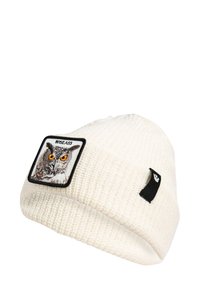 Berretto bianco lavorato a maglia con superficie testurizzata, caratterizzato da una toppa quadrata con un design di un gufo e la parola "WISEASS" in lettere nere.