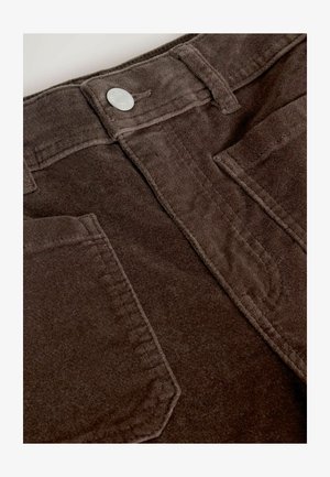 Brown corduroy pants with a textured surface, five-pocket design, and a silver button detail at the waistband.