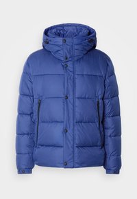 Doudoune matelassée bleue avec capuche, poches latérales zippées, boutons-pression à l'avant et poignets réglables sur un fond neutre.