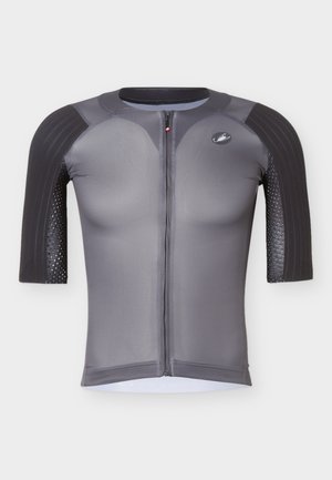 Šedé sportovní kompresní tričko s krátkým rukávem, černě polstrovanými rameny a předním zipem, zobrazené na bílém pozadí.