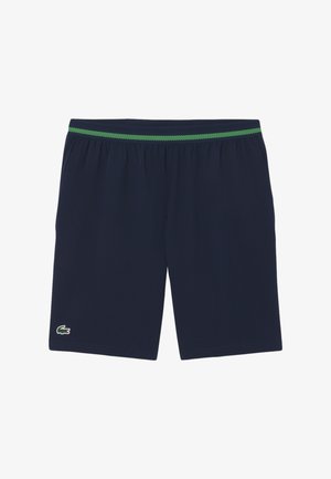 Marineblauwe sportbroekjes met een elastieken tailleband met groene strepen en een klein groen krokodillenlogo op het linkerbeen.