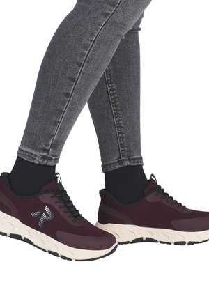 Maroon mesh sneakers with black accents, white sole, and a patterned rubber tread. Worn with dark gray skinny jeans.