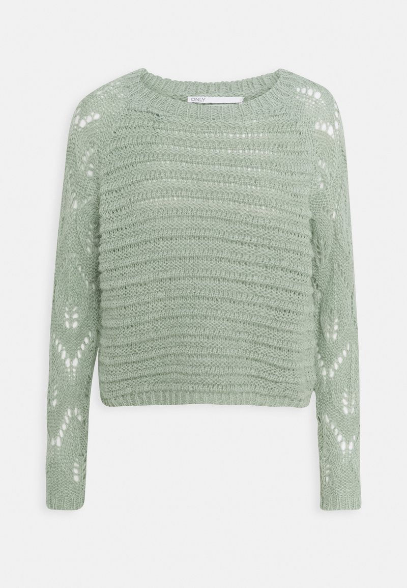 Jasnozielony, dziergany, krótki sweter z długim rękawem, okrągłym dekoltem i ażurowym wzorem na rękawach i korpusie.