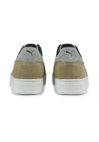 Brown and gray suede sneakers with white rubber soles, featuring textured accents and a black logo on the heel and tongue.