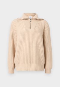 Pull en tricot côtelé beige avec manches longues, col à demi-fermeture éclair, et larges poignets et ourlet côtelés.