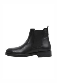 Black leather Chelsea boots with elastic side panels, rounded toe, and pull tab. Smooth texture and flat rubber sole for stability.