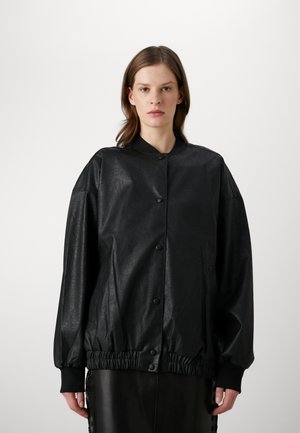 Black faux leather bomber jacket with a relaxed fit, ribbed cuffs, and snap button closure. Features side pockets and a slightly gathered hem.