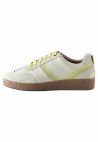 Light gray leather sneaker with lime green accents, textured sole, and round toe. Features padded collar and contrasting laces.
