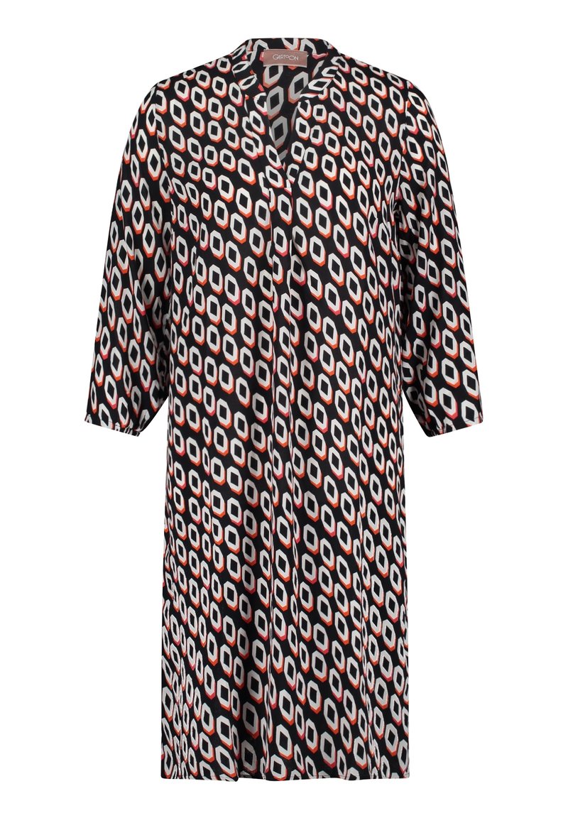 Paino mekko mustalla pohjalla, jossa on geometrinen kuvio valkoisissa, punaisissa ja harmaissa sävyissä. Siinä on lovettu kaulus ja kolmennesosa hihat.