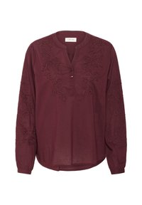Maron farvet langærmet skjorte med rund halsudskæring, bortset fra dekorativ broderi langs ærmerne og brystet; inkluderer en knapdetalje ved kraven.