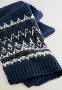 Tamsiai mėlyna megzta šalikas, pagamintas iš minkštos vilnos, su raštuotu dizainu baltos ir rudos spalvos, turintis corrugato apdailą ir tekstūruotą paviršių.