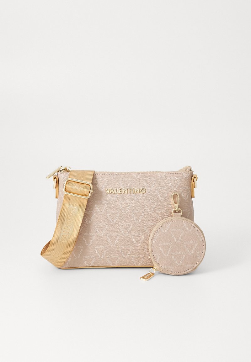 Beige leather handbag with gold hardware, featuring a textured pattern and adjustable strap. Includes a matching round coin pouch.