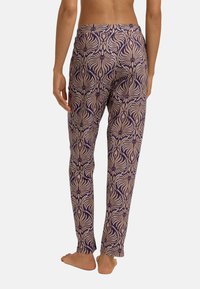 Lila och beige mönstrade leggings med ett blommigt mönster, gjorda av lättviktig tyg, med en figurnära silhuett och elastisk midja.