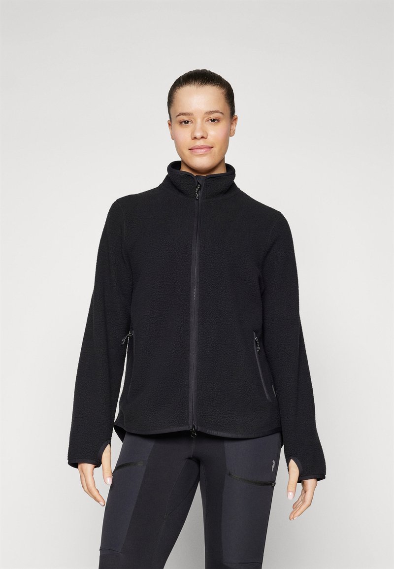 Black fleece jacket with a high collar, full zip front, and side zippered pockets. Features a textured surface and relaxed fit.