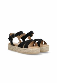 Sandalias negras con tiras y hebilla ajustable, que cuentan con una suela de plataforma de cuerda trenzada y una plantilla de cuero suave.