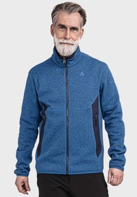 Blaue Fleecejacke mit hohem Kragen, Reißverschluss vorne und navyblauen Akzenten. Verfügt über zwei Reißverschlusstaschen und eine strukturierte Oberfläche.