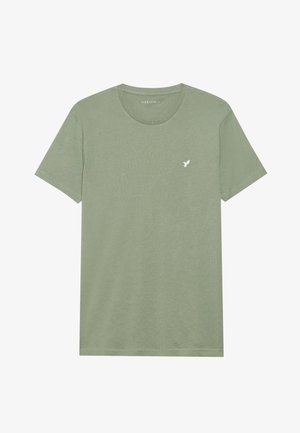 T-shirt en coton vert olive avec un col ras du cou, des manches courtes et un petit logo d'oiseau blanc sur la poitrine gauche. Texture douce et coupe décontractée.