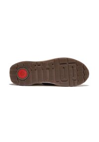 Semelle de chaussure légère présentant une texture ondulée, en matériau caoutchouc beige, et un logo circulaire rouge proéminent avec des détails en relief.