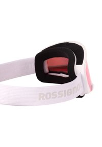 Lyžařské brýle s bílým páskem, s šedým logem "ROSSIGNOL", černou pěnovou vnitřní výplní a tónovanými růžovými skly pro lepší viditelnost.