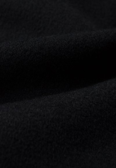 Black fleece fabric with a soft, textured surface; smooth appearance with a matte finish. A close-up view highlights the fabric's depth and weave.