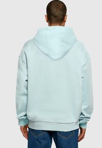 Lyseblå oversized hoodie med en kængurulomme og ribbede manchetter. Blød tekstur, med en stor hætte bagpå.