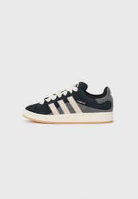 Black suede sneaker with beige stripes and white laces, labeled "CAMPUS," against a plain white background.