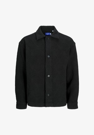 Schwarzes übergroßes Hemd mit Knöpfen und einem strukturierten geometrischen Muster, mit klassischem Kragen und langen Ärmeln, aus einem strukturierten Stoff gefertigt.