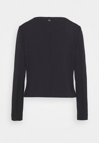 Veste noire cintrée à manches longues avec un col rond et un petit bouton argenté en haut au centre du dos.