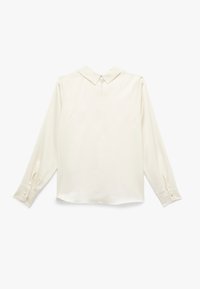 Blusa a maniche lunghe color crema realizzata in tessuto liscio, con colletto a punta, polsi abbottonati e un leggero luccichio. Fit sagomato con orlo dritto.