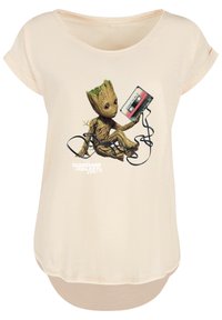 Light beige t-shirt with a round neckline and rolled short sleeves. Features a graphic of a character holding a cassette tape and cords.