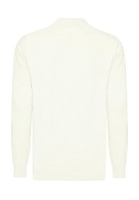 Ljus krämfärgad stickad tröja med en texturerad yta, rund halsringning och långa ärmar. Har ribbad mudd och nederkant. Enkelt mönster.