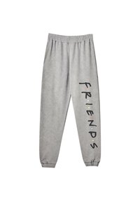 Grå svedbukser med elastisk talje og manchetter, prydet med ordet "FRIENDS" i sorte bogstaver med farvede prikker langs det ene ben.