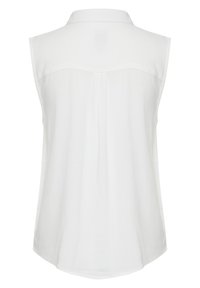 Blouse blanche sans manches avec un col à revers, texture lisse, présentant une couture centrale et un ourlet incurvé en bas.