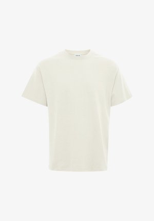 T-shirt beige tinta unita a maniche corte con scollo rotondo, vestibilità regolare ed etichetta visibile sul collo, mostrata su sfondo bianco.