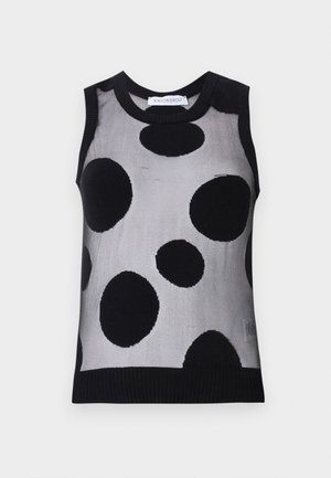 Haut en tricot sans manches noir et gris avec de grands pois noirs sur un fond gris clair. Encolure et ourlet côtelés.