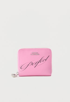 Ροζ πορτοφόλι Marc Jacobs με ασημί φερμουάρ και τη λέξη «Perfect» γραμμένη διαγώνια με μαύρο γράμμα μπροστά.