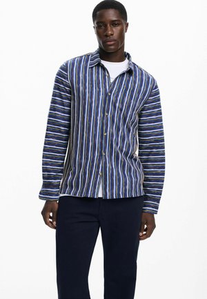 Striped button-up shirt in blue, white, and green hues. Features a collar, long sleeves, and soft texture with a relaxed fit design.