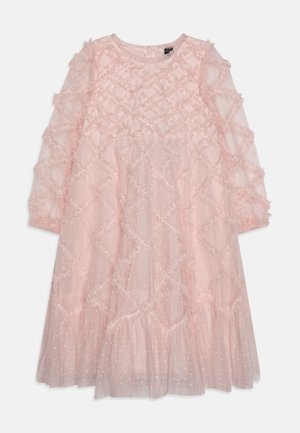 Light pink dress featuring a textured fabric with ruffled accents, long sleeves, and a layered hemline. Polka dot pattern throughout.