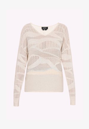 Vaaleanbeige neulepusero, jossa on V-pääntie, pitkät hihat, teksturoitu neulekuvio ja vaihtelevaa läpinäkyvyyttä ja tiheää kangasta eri osissa.